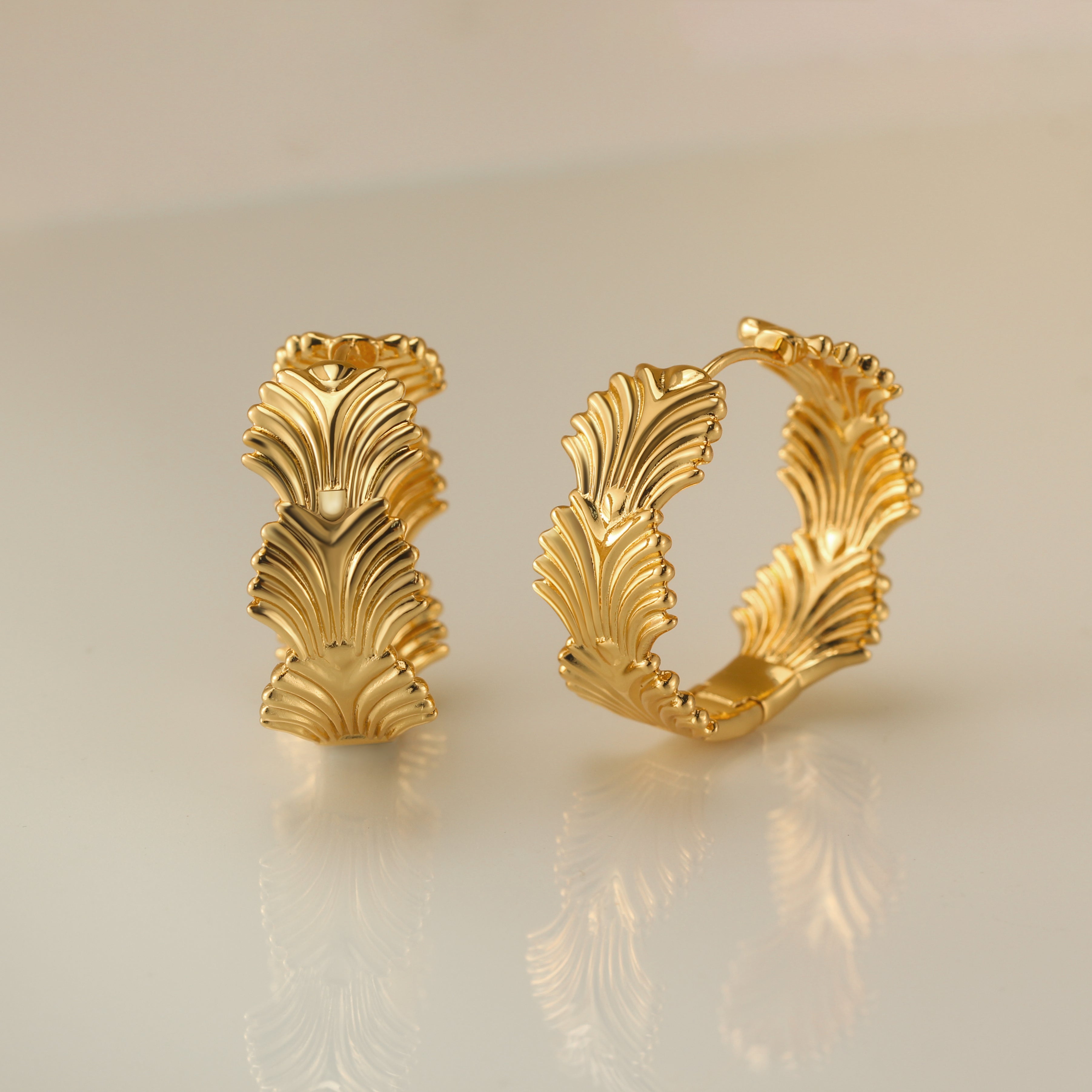 Chic foliage hoop earrings adorned with intricate leaf designs, crafted from durable sterling silver, perfect for adding a touch of nature-inspired elegance to any outfit