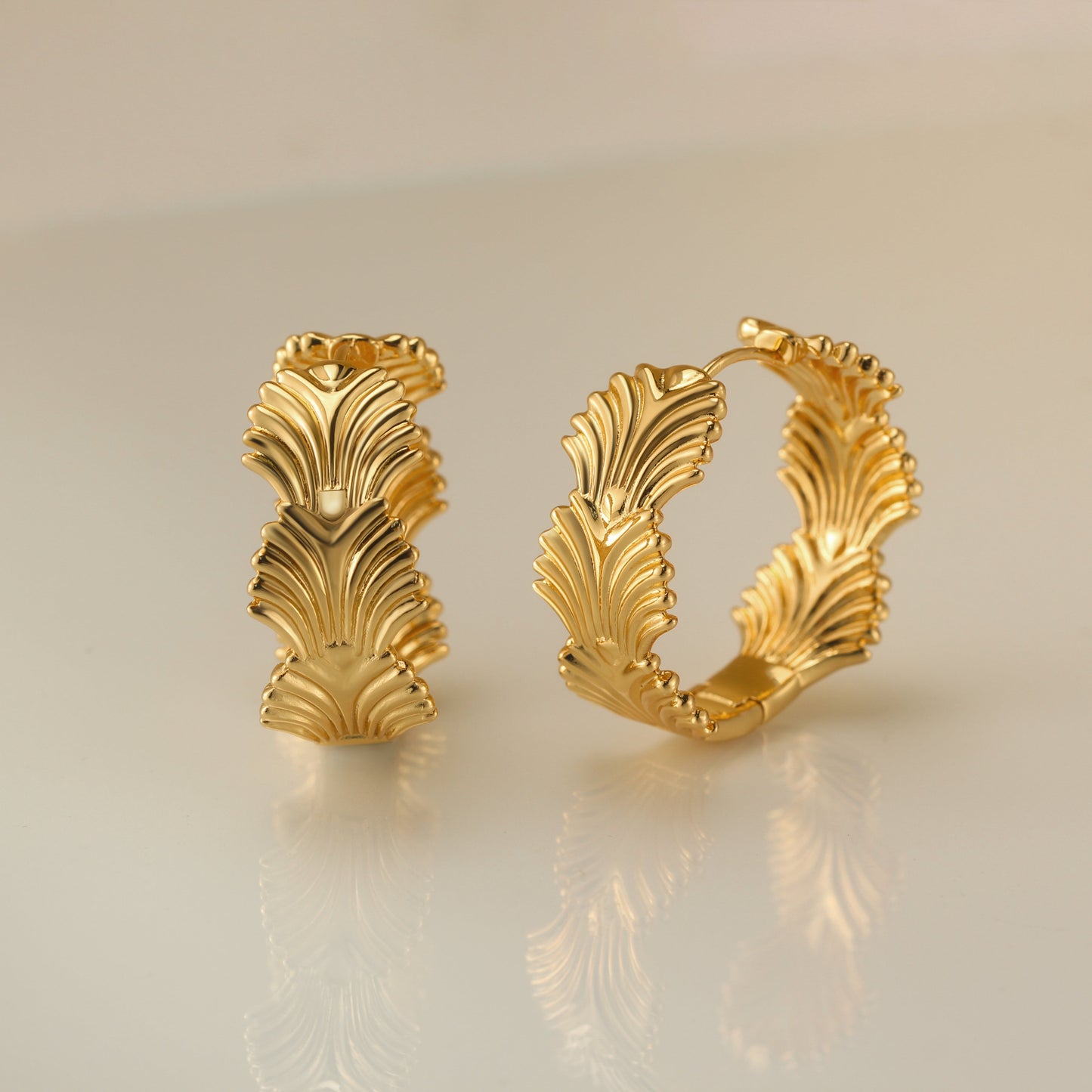 Chic foliage hoop earrings adorned with intricate leaf designs, crafted from durable sterling silver, perfect for adding a touch of nature-inspired elegance to any outfit