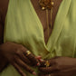 Bayahíbe Bloom Lariat Necklace with gold Rosa de Bayahíbe pendant on bamboo chain, worn with matching rings.